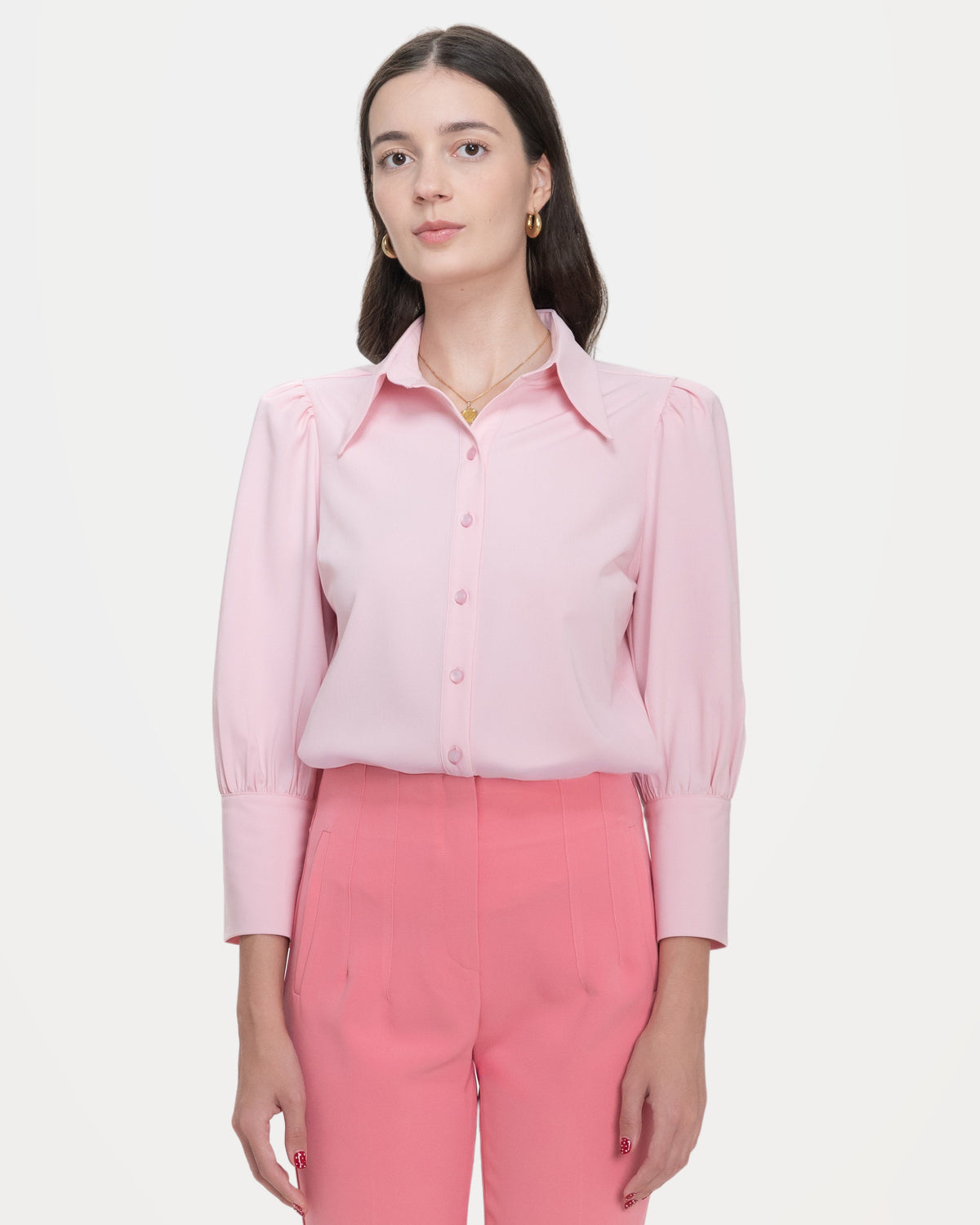 The pale pink blouse from the front: the long point collar, gathered shoulders and deep buttoned cuffs.